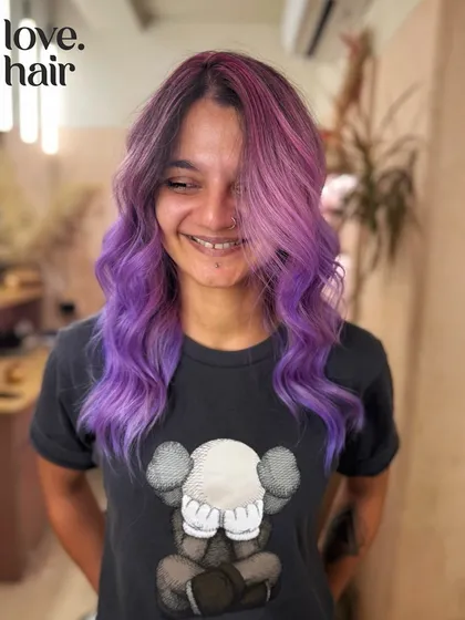 Cotton candy dreams. A beautiful blend of pink and purple tones creates this dreamy, pastel-punk balayage.