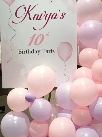 A personalized welcome sign for Kavya's 10th birthday, coordinated with the party's pink and purple color scheme.