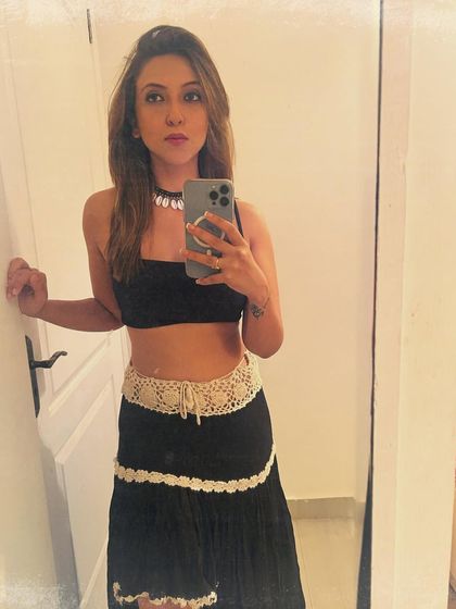 A mirror selfie from the start of a new year. This black crop top and tiered skirt with crochet details has a fun, bohemian vibe.