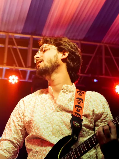 My talented guitarist lost in the music during a live set. My band is the backbone of my performance.