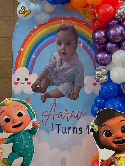 A personalized photo board for Aarav's birthday, featuring a large picture of the birthday boy alongside his favorite Cocomelon characters.
