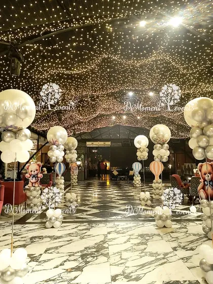 The entire venue is filled with magic, with tall hot air balloon centerpieces and a ceiling covered in thousands of twinkling fairy lights.
