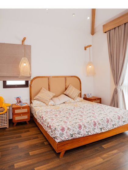 A Japandi-themed bedroom with a low wooden bed, rattan headboard, and simple, nature-inspired decor. The focus is on intention and elegance without excess.