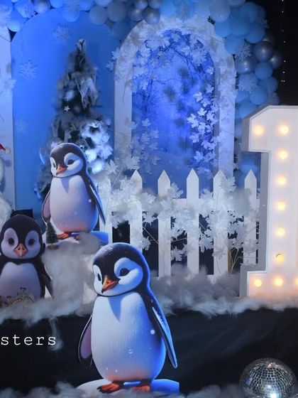 Penguins and a light-up number '10' create a perfect photo spot at this winter-themed birthday celebration.