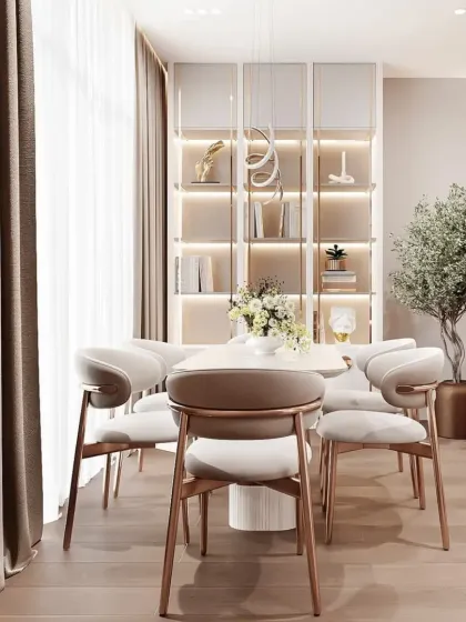 This dining area features a beautiful built-in crockery unit with internal lighting. The elegant chairs and minimalist table create a sophisticated space for family meals.