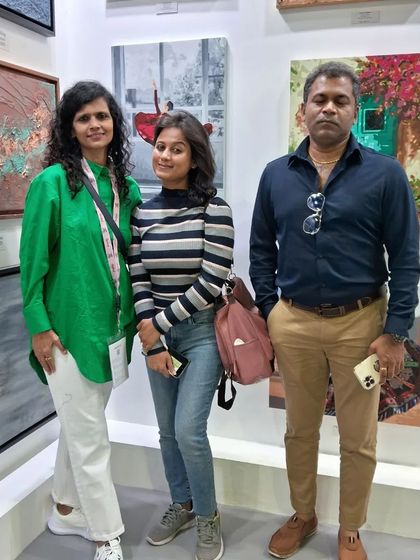 Artist Ria Aboobakar with her family at her exhibition booth. We understand that an artist's journey is supported by their loved ones, and we welcome them into our community.