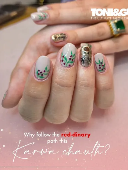 Getting ready for Karwa Chauth with a festive nail design. This look features delicate leaf patterns and a touch of gold glitter on a neutral base, offering a unique twist on traditional red.