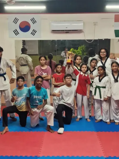 The whole team celebrates a tournament victory. Holding the championship trophy together reinforces our values of teamwork and shared success.