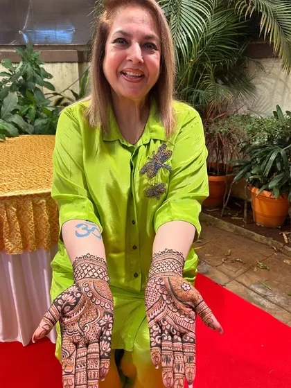 A happy client showing off both the front and back of her hands. I created two different but complementary designs for her.