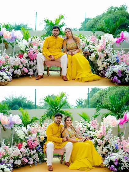 A beautiful portrait of the couple surrounded by a stunning floral arrangement. Their coordinated yellow outfits look perfect for the Haldi ceremony.