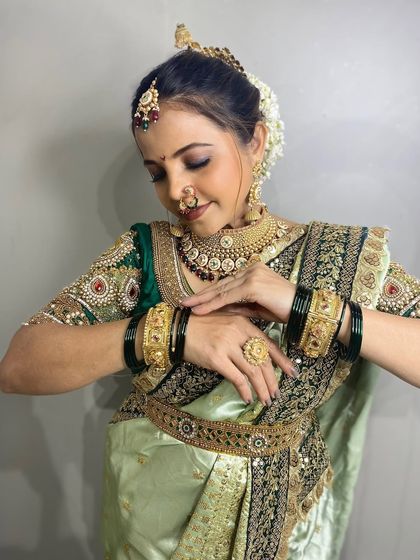 A light green Nauvari paired with a dark green embroidered blouse, a sophisticated choice for any event.