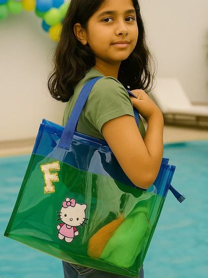 This personalised jelly tote bag is perfect for a day at the pool. The clear material is waterproof, and we can customise it with an initial and a Hello Kitty patch.