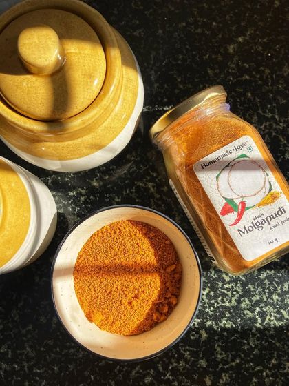A closer look at the star ingredient. Our Molgapudi is shown here in a bowl next to a traditional pickle jar, highlighting its fine texture and rich colour, ready to be used in your favourite recipes.