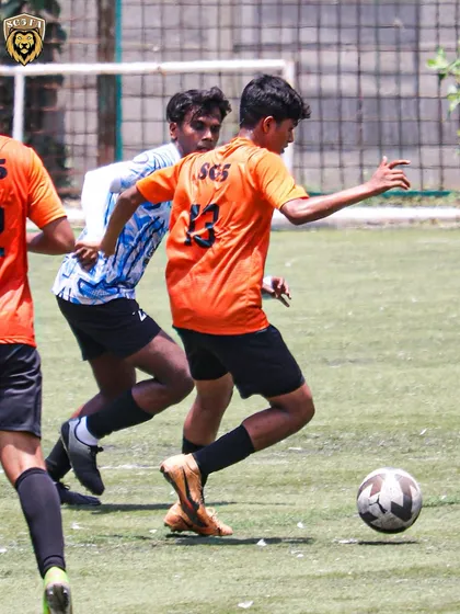 Our players working together to move the ball up the pitch, demonstrating fluid teamwork.