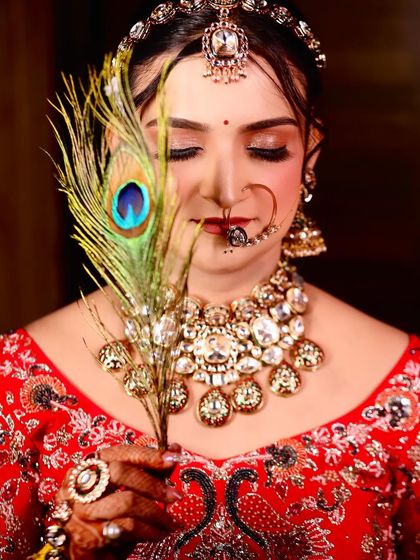 My beautiful bride Swati, with a peacock feather. A creative shot that highlights her soft eye makeup and stunning jewellery.