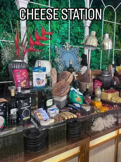 Our gourmet cheese station is a feast for the eyes and the palate. It features a curated selection of international and local cheeses, artisanal breads, crackers, nuts, and fruits, presented as an abundant, grazing-style spread.