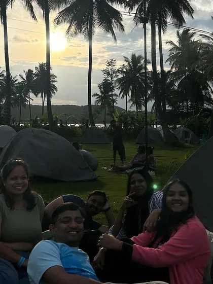 Gather your squad and create lasting memories. A group of friends enjoys the sunset at our campsite after a day of fun activities.