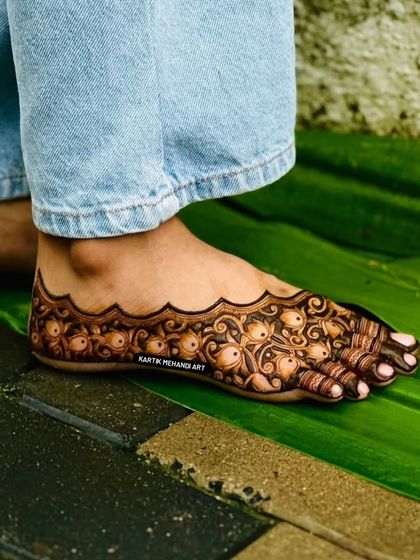 The rich color of our natural henna is visible in this close-up of a foot design, placed on a green leaf to highlight the beautiful stain.