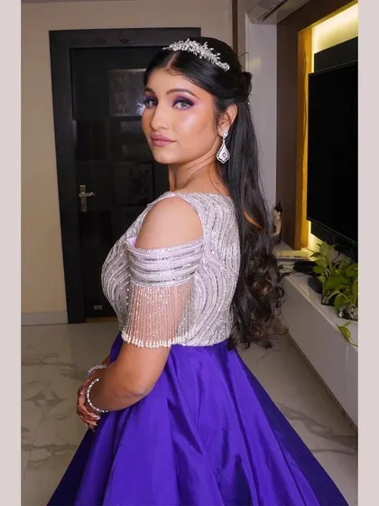 A modern princess look for a Roka ceremony. The purple eyeshadow complements her gown beautifully, and the delicate tiara adds a touch of fairytale magic. Her skin is kept fresh and glowing.
