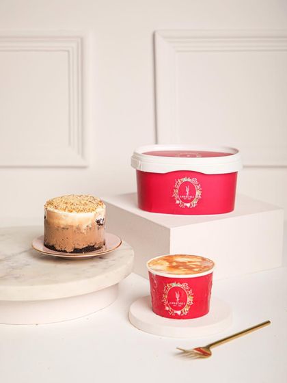 Our ice cream cake tubs are layered, luscious, and prepared to melt hearts. Here, a mini cake is shown alongside its larger tub counterpart.