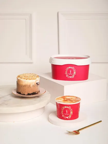 Our ice cream cake tubs are layered, luscious, and prepared to melt hearts. Here, a mini cake is shown alongside its larger tub counterpart.