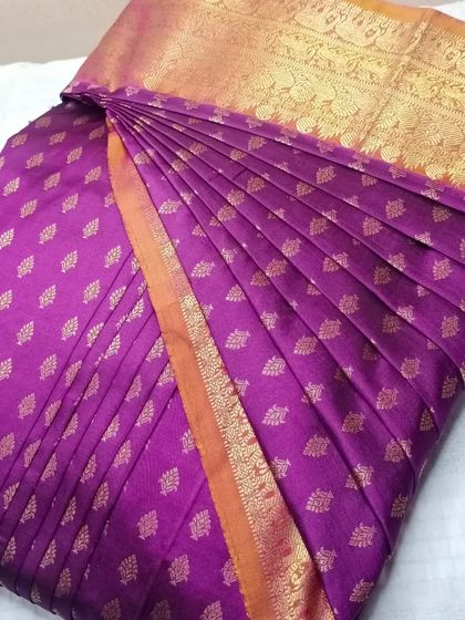 Perfect draping is now possible, always. This purple saree with gold butis is a great example of the flawless finish you can achieve with my service.