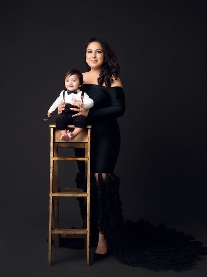 A full-length portrait of a glamorous mother and her dapper son.