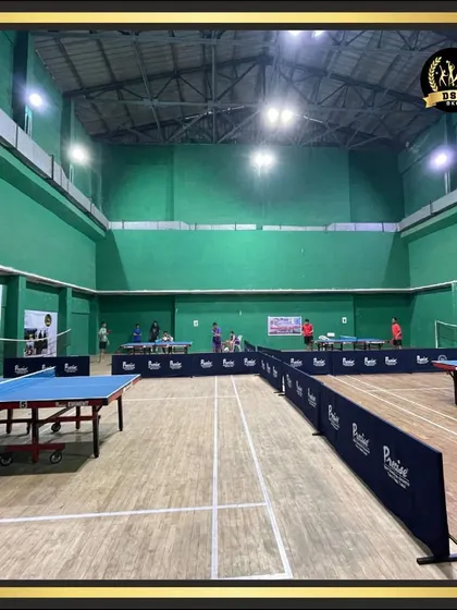 Our expansive indoor hall is a hub of activity, featuring multiple table tennis tables and badminton courts. This well-lit, professional space is designed for everything from casual games to competitive tournaments.
