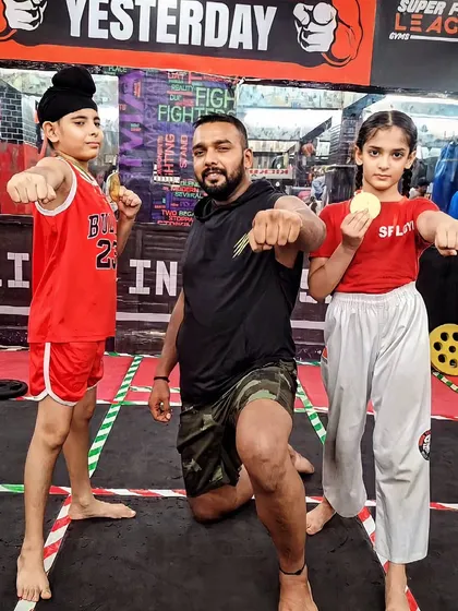 My little fighters. I teach them to be strong and confident. Here I am with two of my young students after they won medals in a competition.