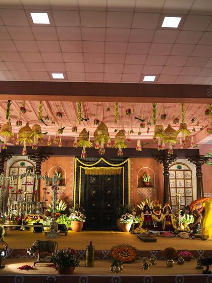 A wide perspective of the naming ceremony stage, showing how all the different elements come together. The lighting is designed to highlight the intricate details and create a warm, inviting ambiance for the celebration.