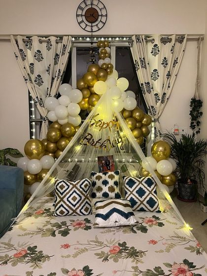 A full view of the romantic birthday tent, showing how it creates a beautiful focal point in the room.