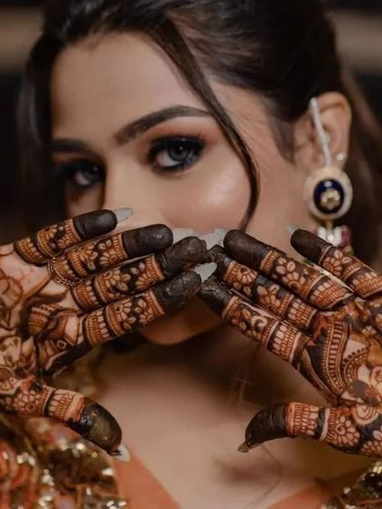 A striking close-up of a bride, with her dark, detailed mehndi providing a beautiful contrast.