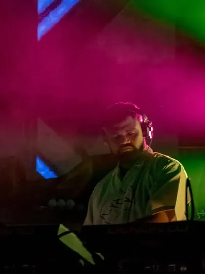 A shot of me at the decks with vibrant pink and green lights, showing the colorful and dynamic production of the Innellea tour.