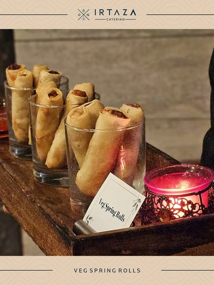 Classic Veg Spring Rolls, served in individual glasses for a clean and modern presentation at a cocktail party.
