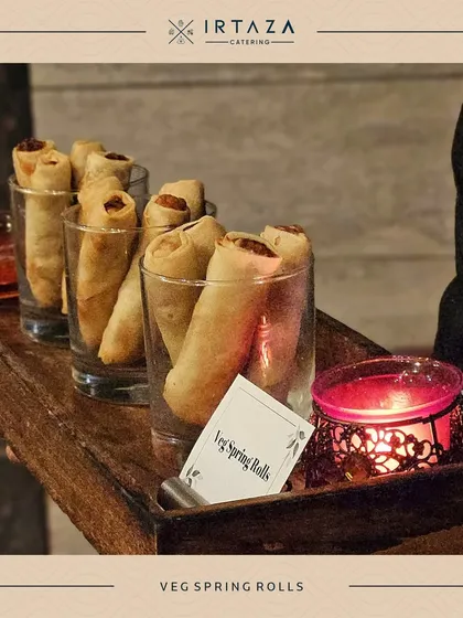 Crispy Veg Spring Rolls served in individual glasses. This presentation keeps them neat and easy to handle, perfect for a cocktail hour or pass-around service.