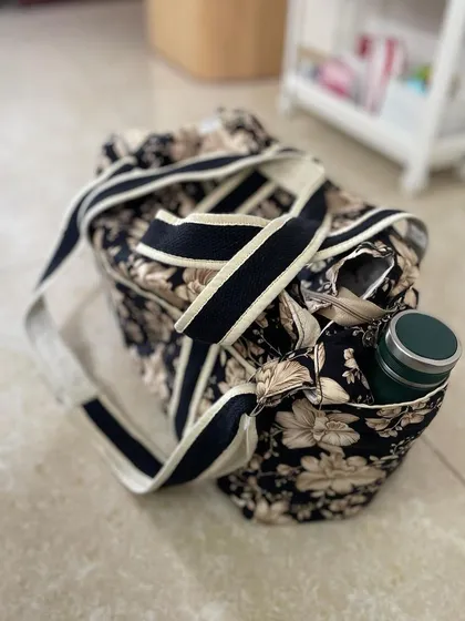 A top-down view of the diaper bag, highlighting the easy-access side pocket, perfect for a water bottle.