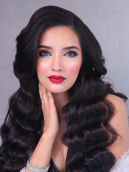 A close-up of the red carpet look, focusing on the flawless skin, sharp eyeliner, and perfectly shaped red lips.