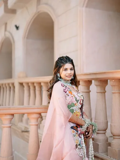 A beautiful Haldi look with soft waves and a double braided crown, creating a bohemian and romantic vibe.