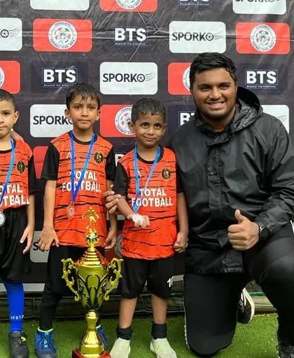 Our U6 team with their coach and runners-up trophy at the Monsoon Cup.