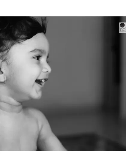 The pure joy of a child's laughter, captured in a timeless black and white photo. This is another beautiful moment from a relaxed lifestyle session at the client's home.