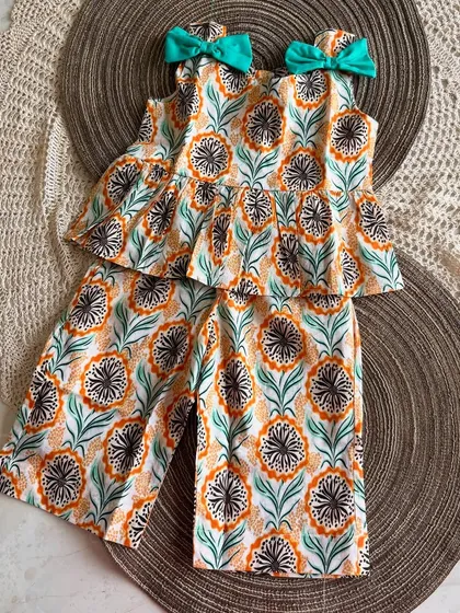 It’s all in the little details. I added these sweet little bows to the shoulders of our floral peplum set. They are stitched on securely, so you get all the cuteness with none of the fuss. Just an easy, adorable outfit for any day.