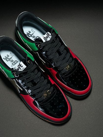 An overhead view of the Bapesta UAE edition, highlighting the asymmetrical color blocking and the Bape head lace dubrae.