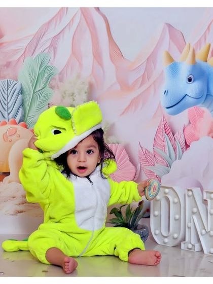 A roaring good time with our dinosaur-themed first birthday shoot. The custom costume and prehistoric backdrop make for a fun and imaginative session.