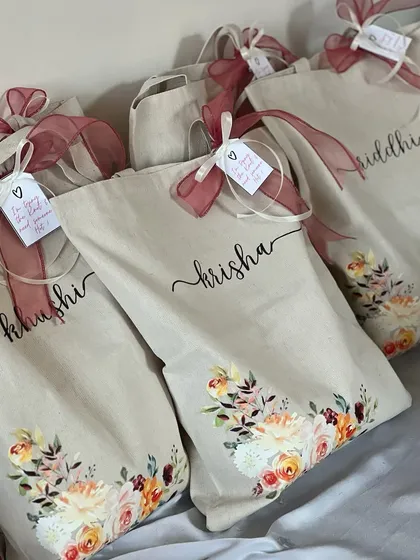 Beautifully personalized tote bags with a floral design. These were created for a bride to gift her squad, each with their name elegantly written on the front.