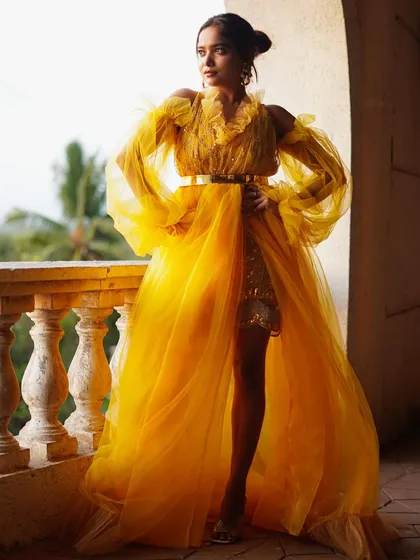 A vibrant, high-fashion shot featuring actress Manisha Rani. The flowing yellow tulle gown against the open-air balcony setting shows my ability to create dramatic, editorial-style images in any location.