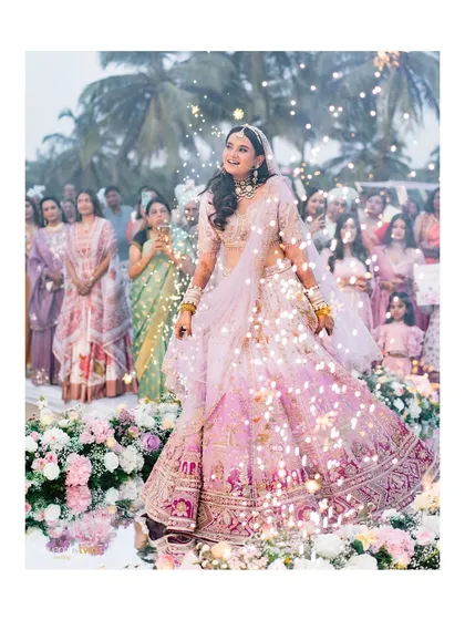 The bride's sparkling entrance at her Goa beach wedding, a magical moment captured with flair.