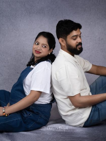 A cute and quirky pose. This couple's playful interaction while reading a book adds a unique touch to their maternity session.