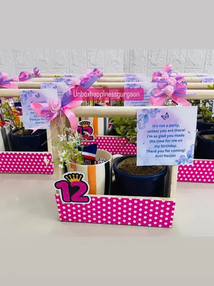 A close-up of the 12th birthday favor, highlighting the personalized butterfly-themed thank you card and the mug filled with treats.