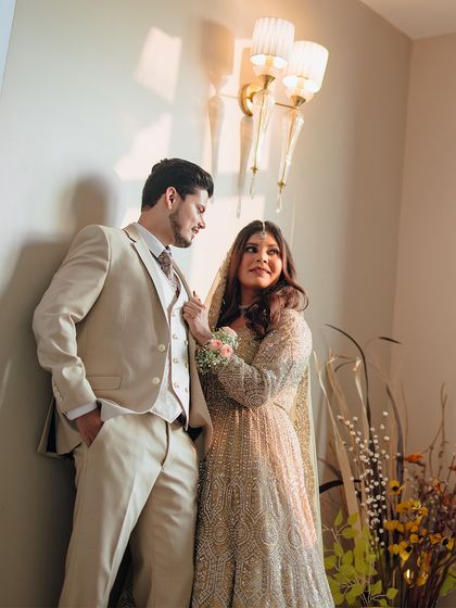 A classic couple portrait, showcasing their elegant engagement outfits and the loving gaze they share.