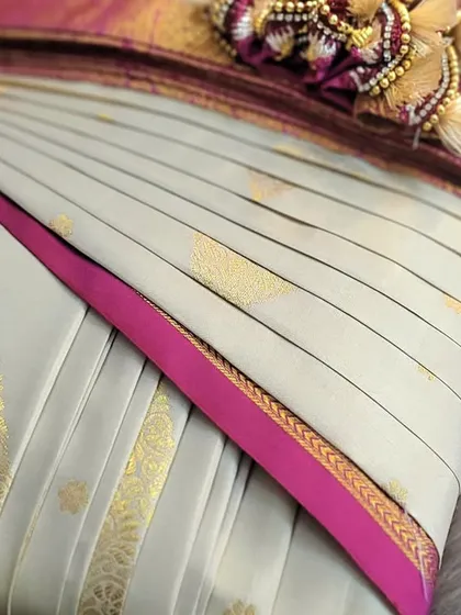 The final look of a pre-pleated bridal saree before it's dispatched. The attention to detail in the pleating and folding guarantees a flawless drape.